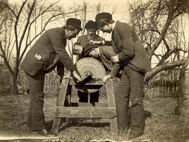 Men Using Grindstone
