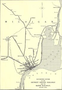 A Black-And-White Printed Map Shows Rail Lines Spreading From Detroit To Pontiac, Flint, Romeo, Mount Clemens, And Port Huron, With Lake St. Clair And The Detroit River Labeled.