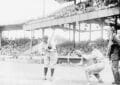 Ty Cobb Stands In A Batting Stance As A Catcher Crouches Behind Him And A Crowded Grandstand Fills The Background