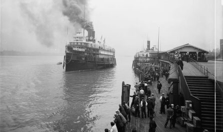 City Of Cleveland Iii - A Large Passenger Steamship Approaches A Pier Crowded With People While Smoke Rises From Its Stacks And Another Ship Sits At The Dock.