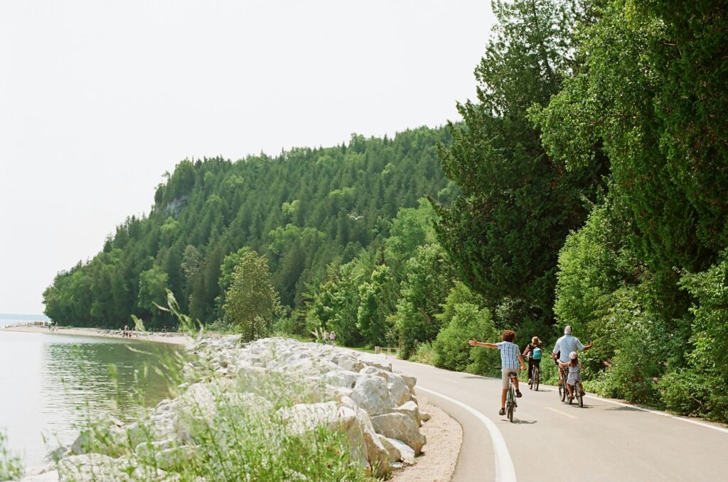People Biking Along A Scenic Path.