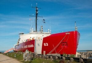 A Red And White Ship On A Dock