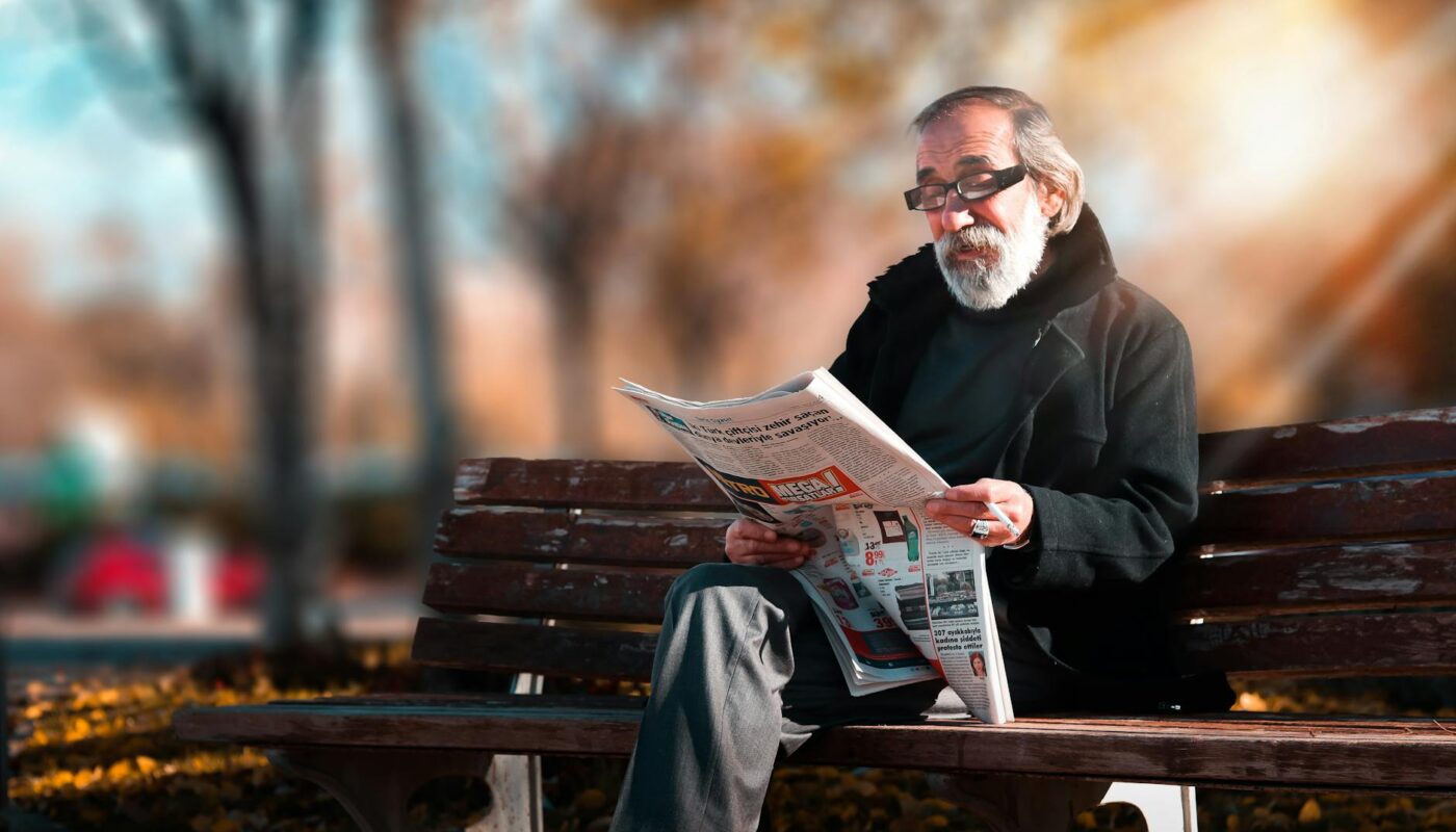 Photo Of Man Reading Newspaper