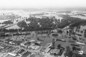 A Flooded Area With Buildings And Trees