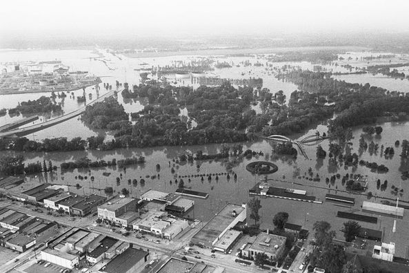 A Flooded Area With Buildings And Trees