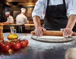 Firefly A Cook Is Rolling Dough For Pizza The Background Is A Busy Kitchen And Chef Out Of Focus T