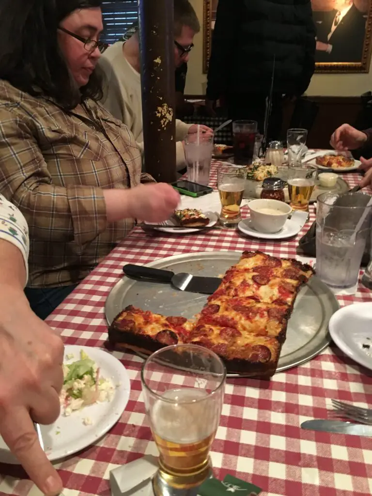 a group of people sitting at a table with food