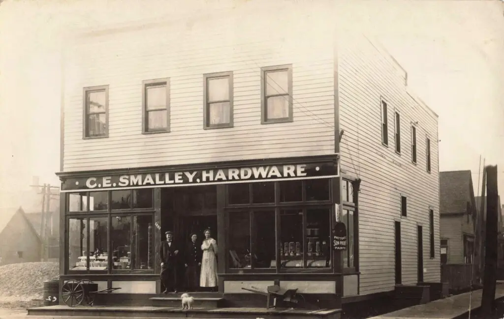 Proprietor C.e. Smalley And Family Stand Proudly In Front Of Their Downtown Hardware Store, Serving Pinconning’s Growing Residential And Farming Needs.