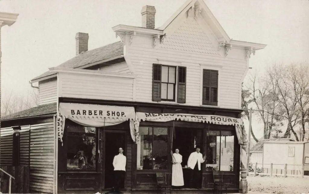 A Group Of People Standing Outside A Store