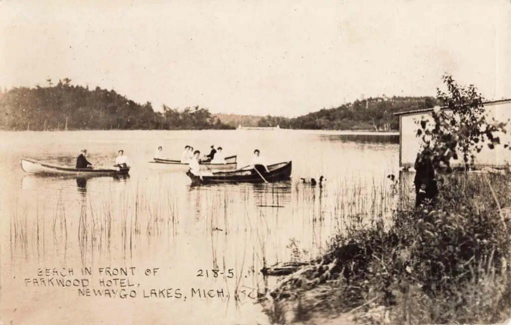A Group Of People In Boats On A Lake