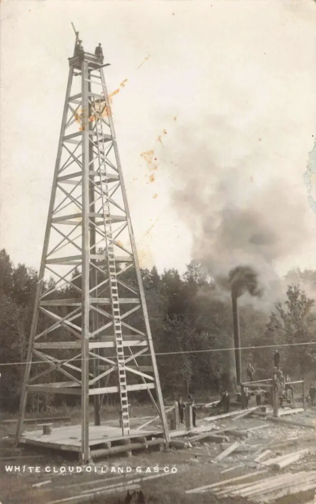 A Tall Metal Tower With Smoke Coming Out Of It
