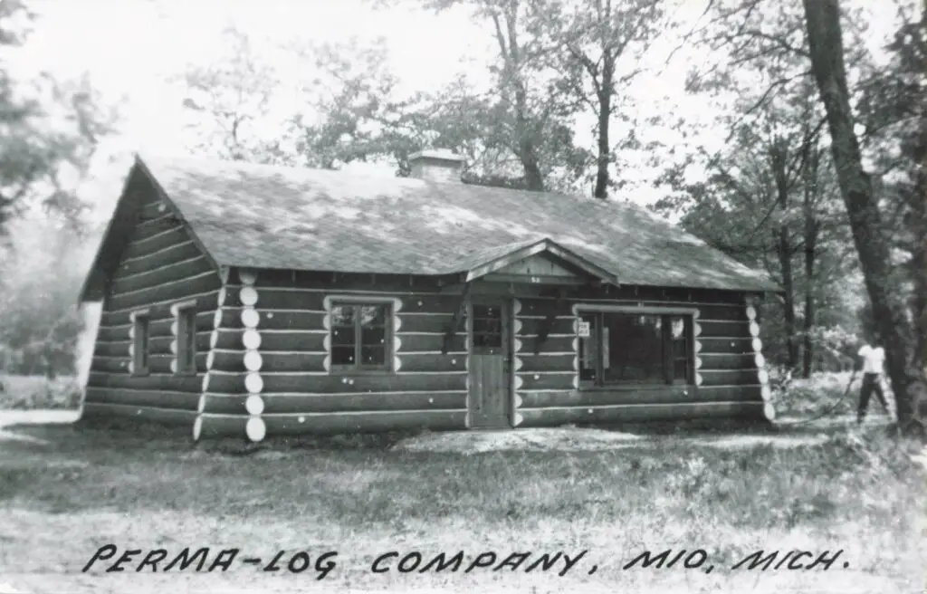 A Log Cabin With Trees In The Background