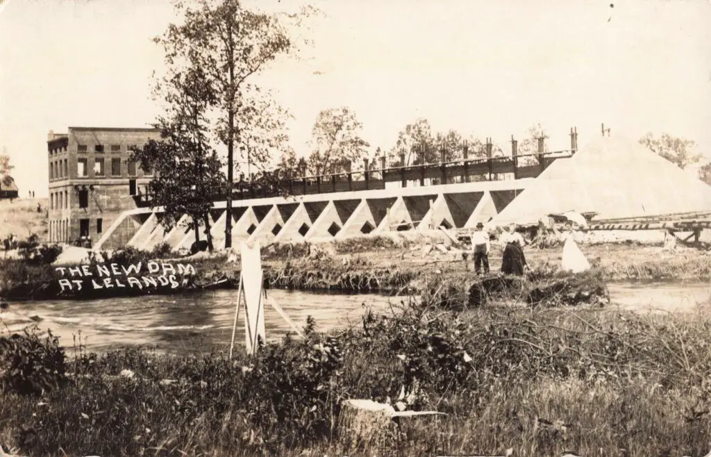 A Group Of People Standing Near A River