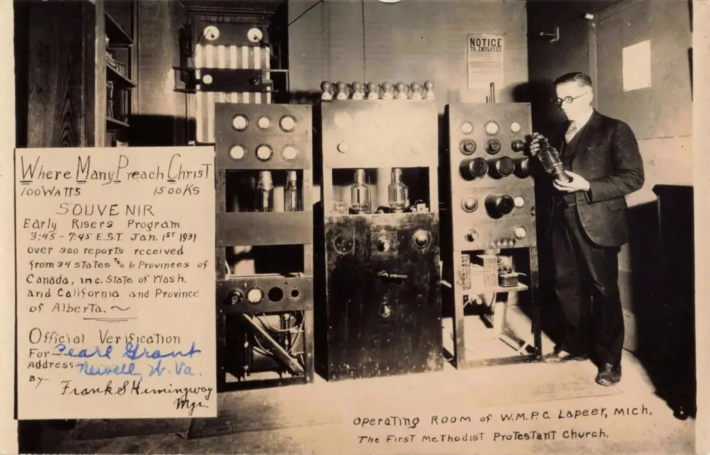 A Man Standing Next To Several Machines