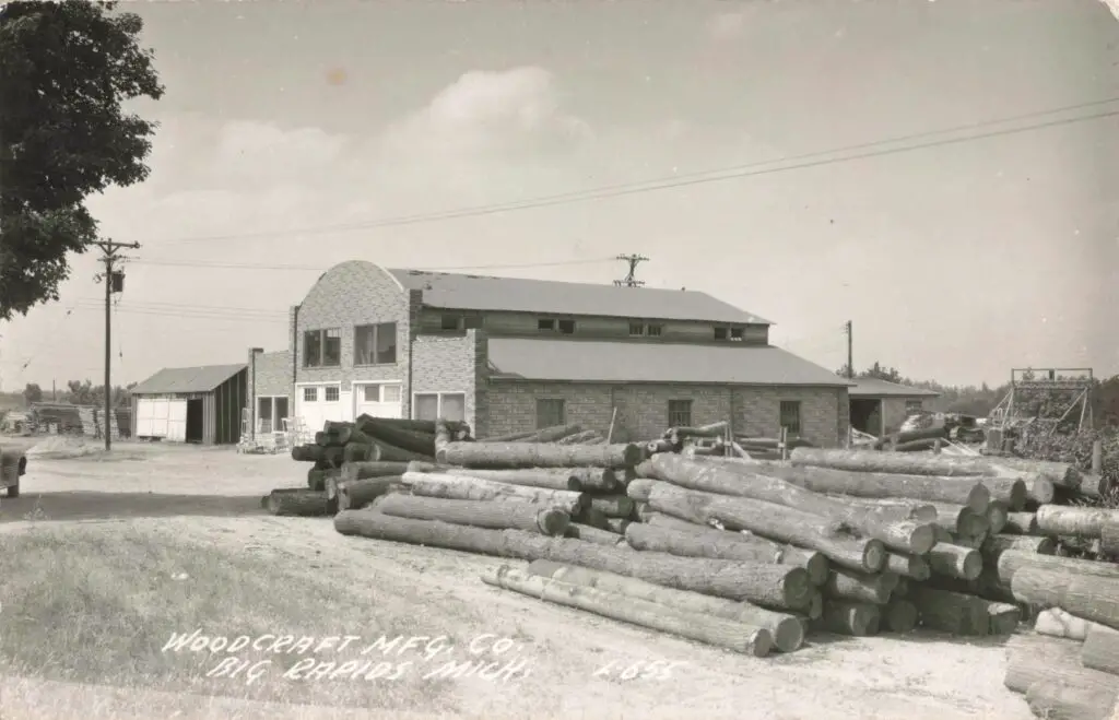 A Large Pile Of Logs Outside A Building