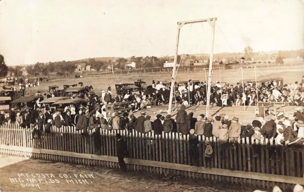 A Group Of People Standing On A Fence