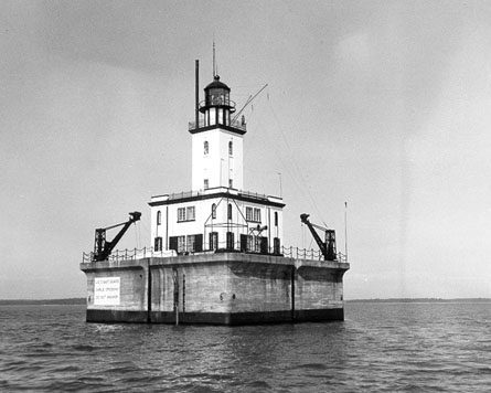 A Lighthouse On A Platform In The Water