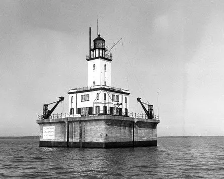 A Lighthouse On A Platform In The Water