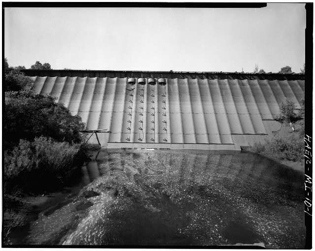 A Large Metal Wall With A Waterfall