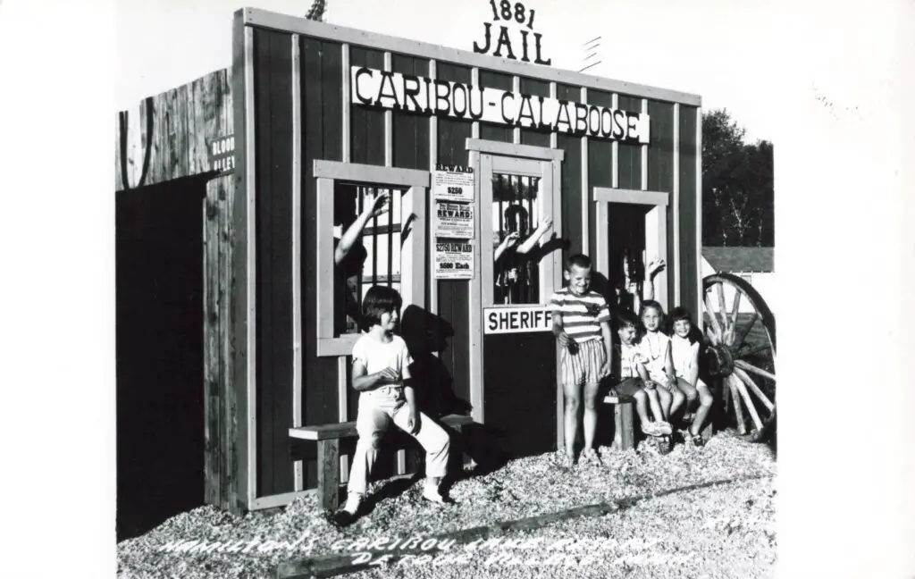 A Group Of Children In Front Of A Jail