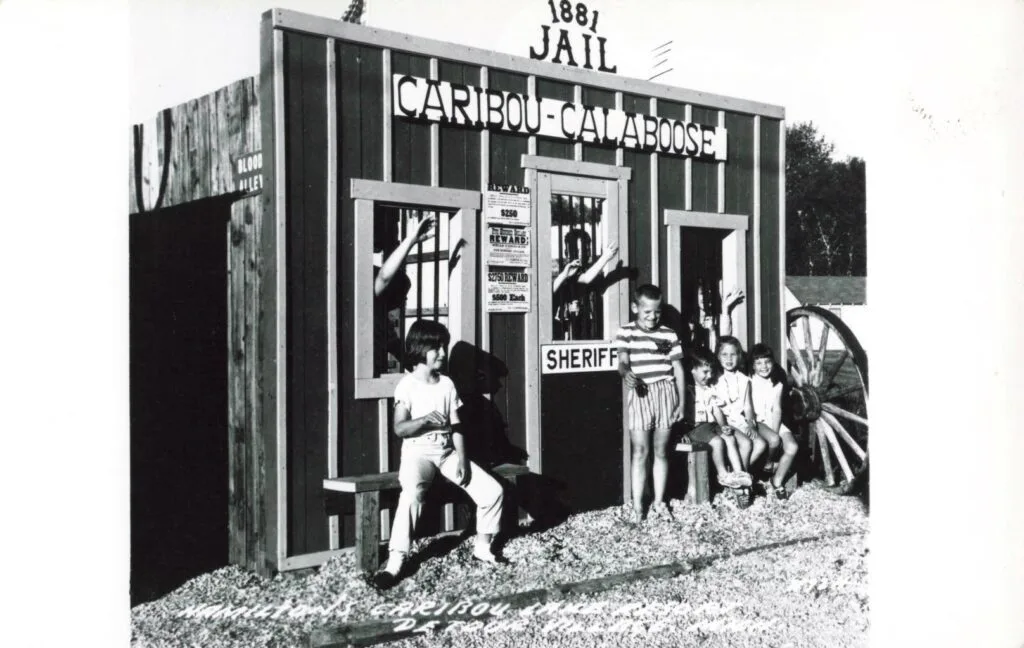 A Group Of Children In Front Of A Jail