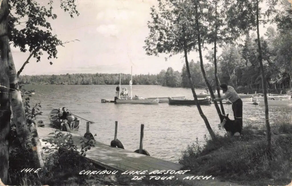 A Group Of People On A Dock Next To A Lake