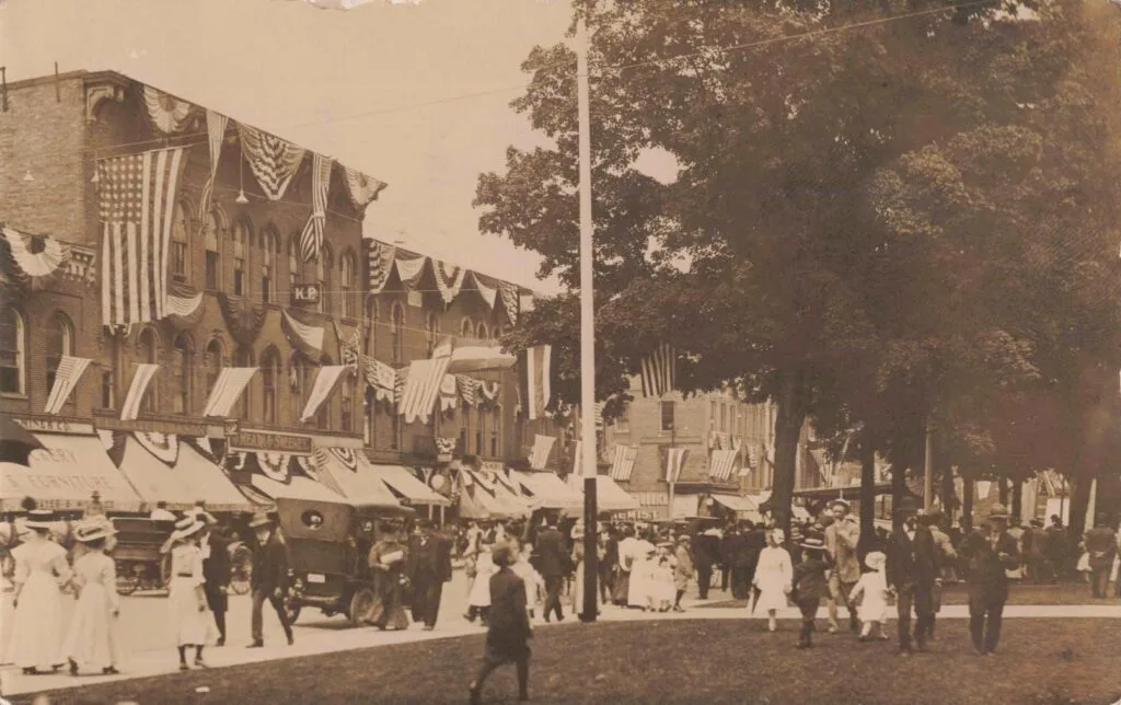 A Group Of People Walking On A Street