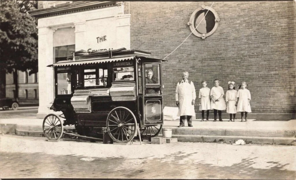 A Group Of People Standing Next To A Horse Drawn Carriage