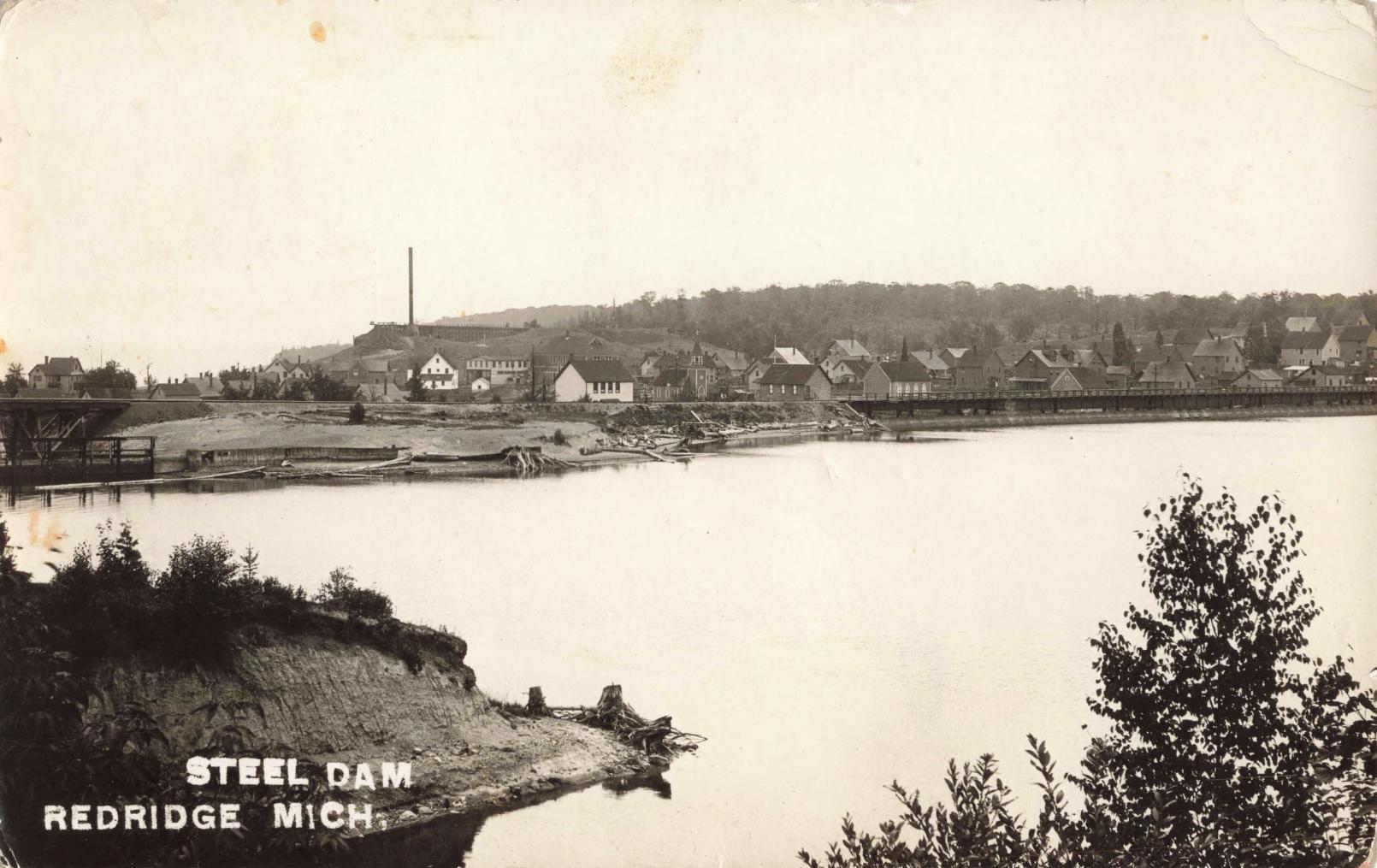 History Of Redridge Michigan - A Black And White Photo Of A Town By A Lake