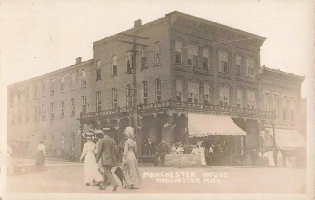 A Group Of People Walking In Front Of A Building