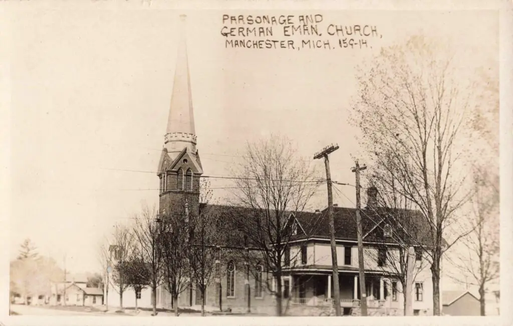 A Church With A Steeple And Trees