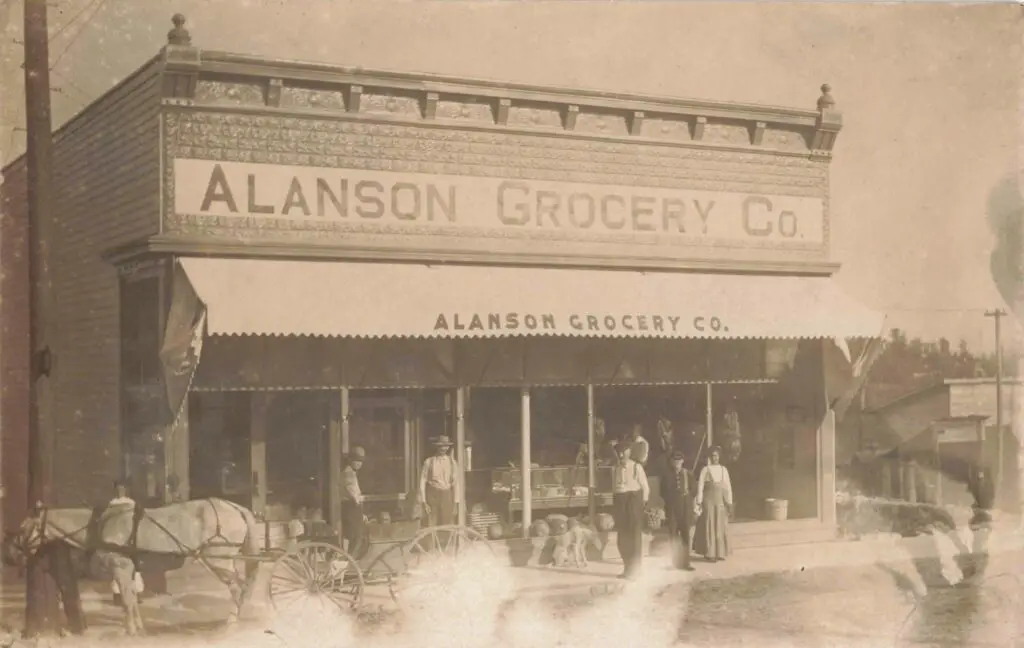 Historic Grocery Store With People Outside.
