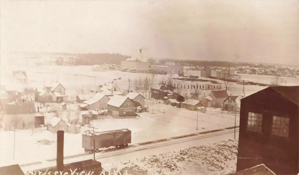 Snow-Covered Town With Wooden Buildings.