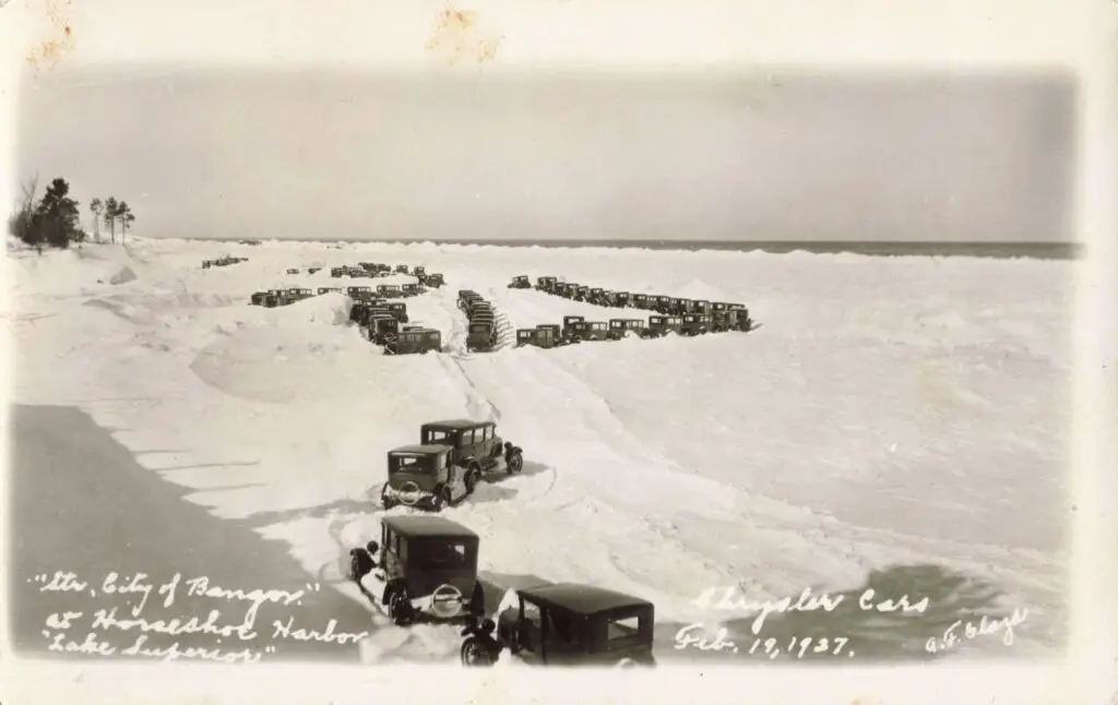 Vintage Cars Lined On Snowy Landscape.