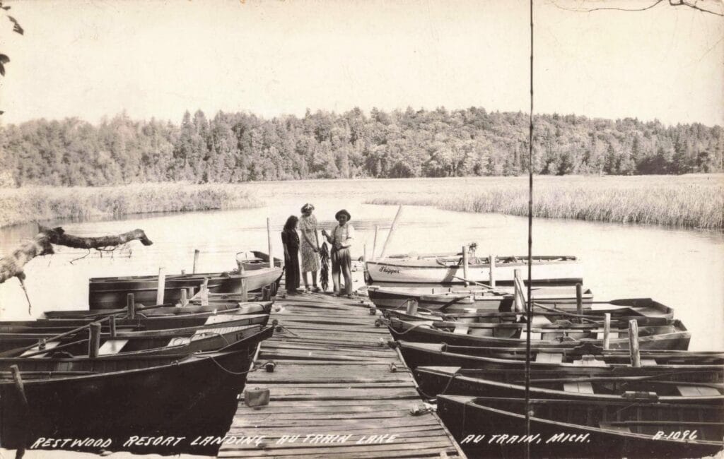 Men By Boats At Tranquil Lake.