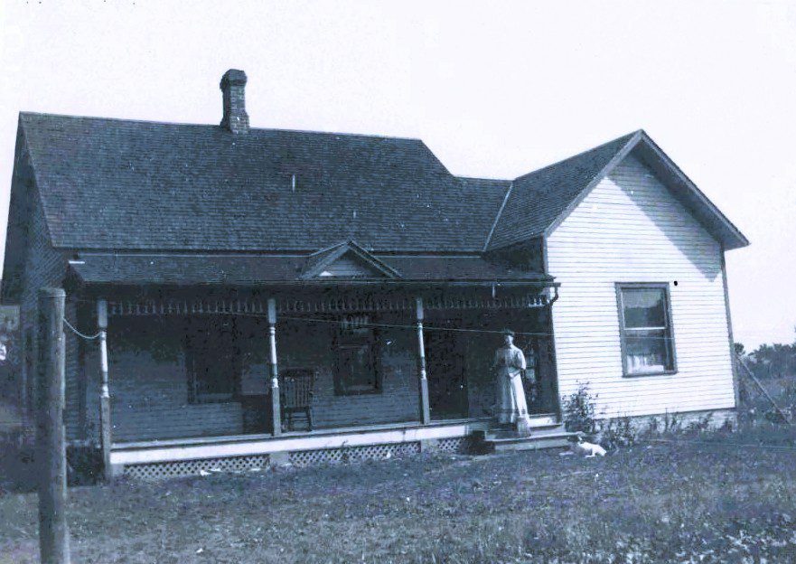 Old House With Woman Standing Outside
