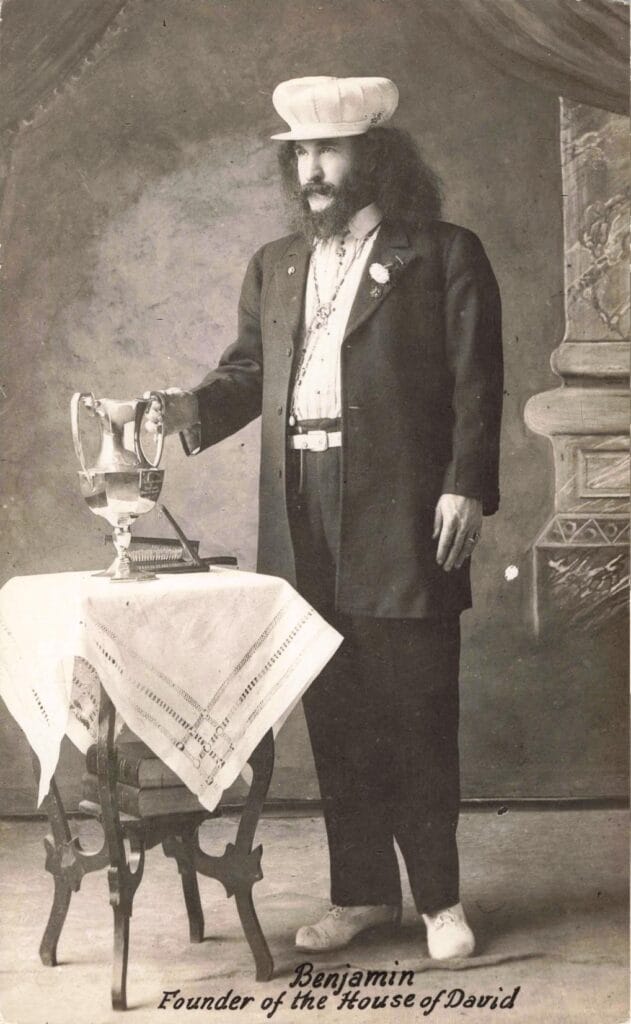 Man In Formal Attire With Trophy.