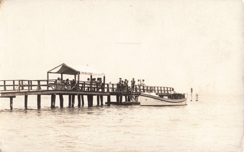 Historic Pier With Boat And People