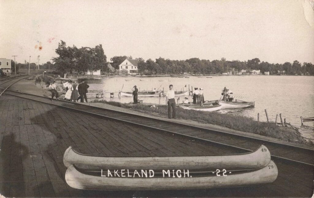 Historic Lakeside Scene With Canoes.