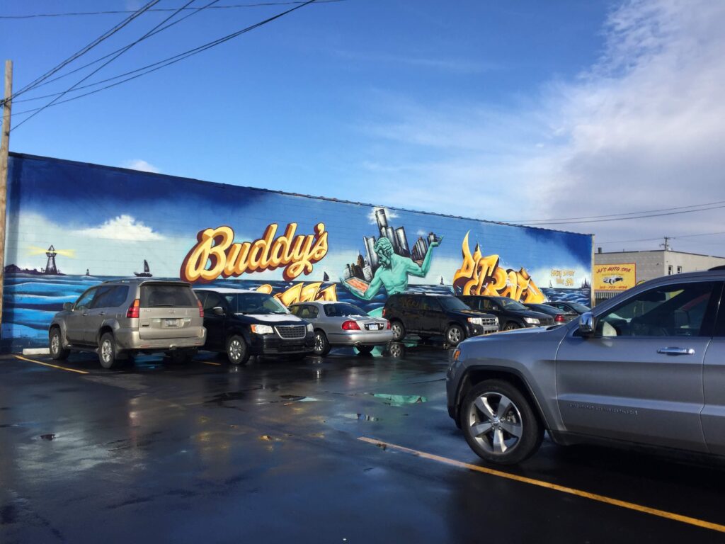 Mural On Building With Parked Cars