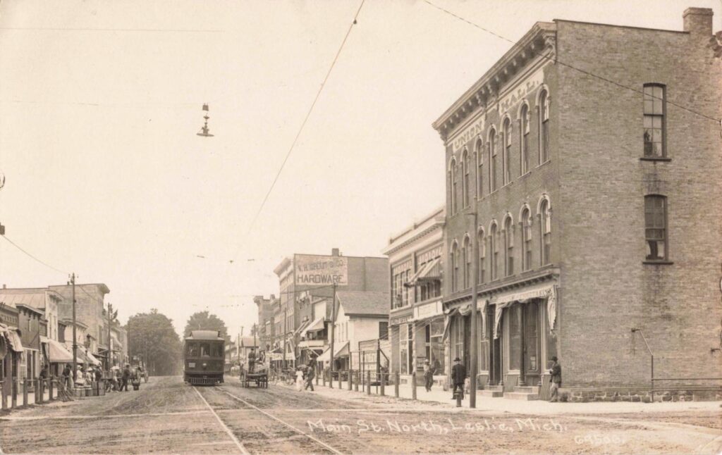 Quiet Historic Downtown Street In Leslie Michigan Showing Preserved Buildings And Light Traffic.
