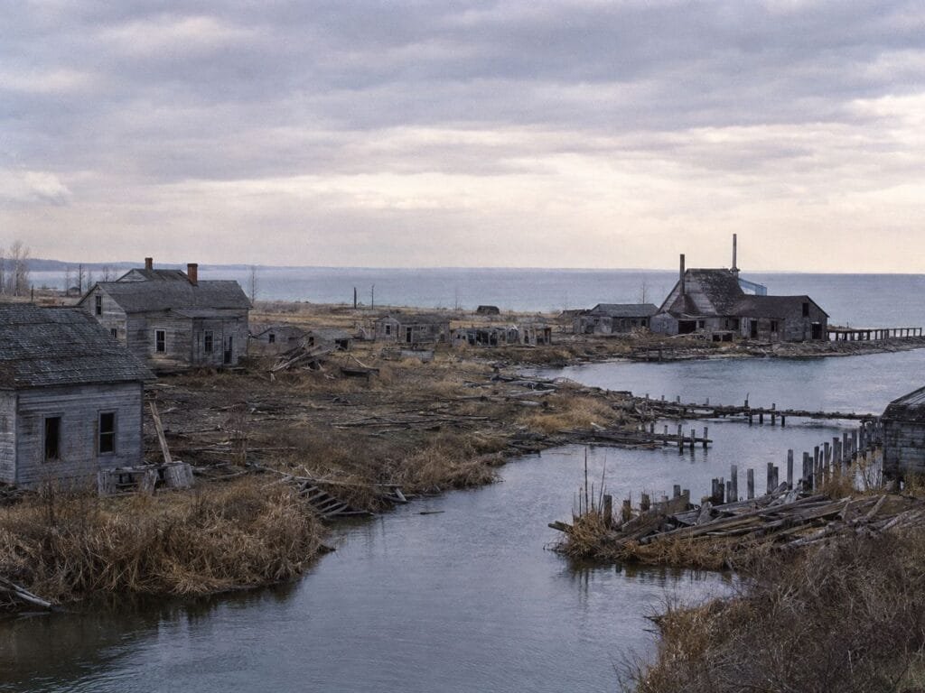 Abandoned Buildings Near A Calm Waterway.