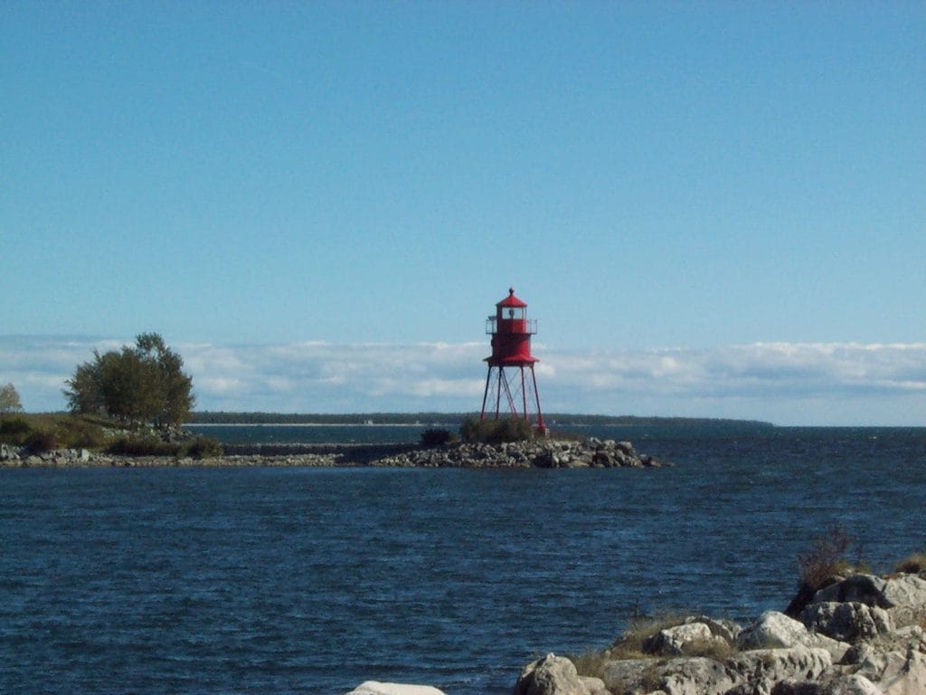 Red Lighthouse By Calm Water