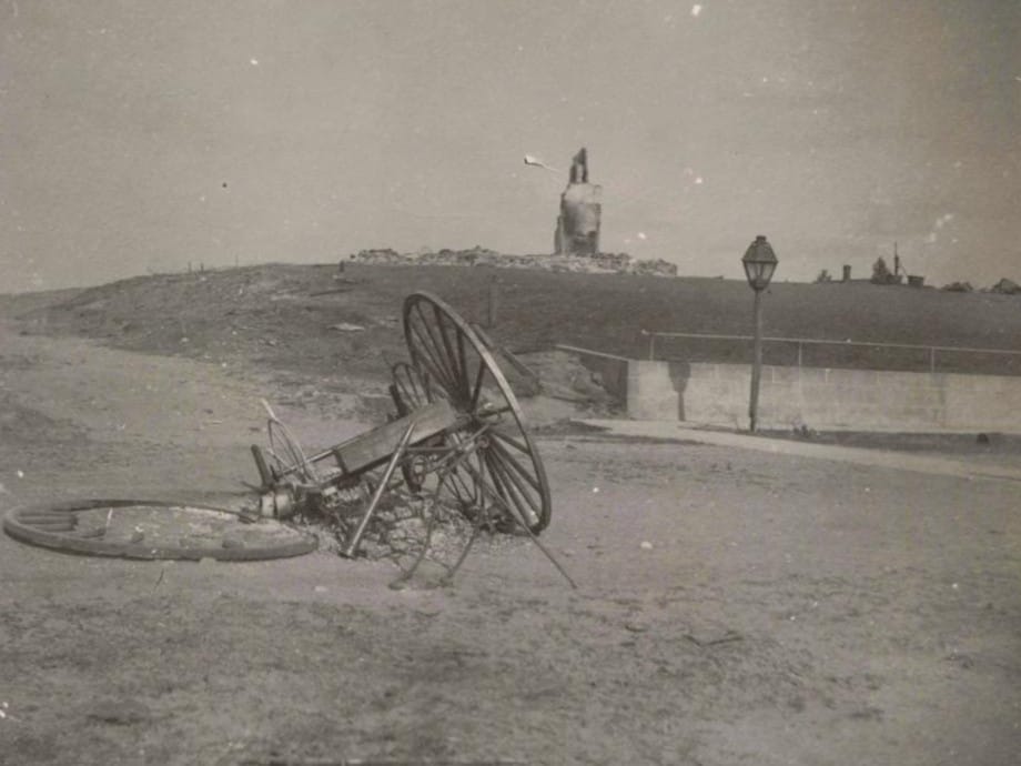 Abandoned Cart Near Fire-Damaged Ruins.