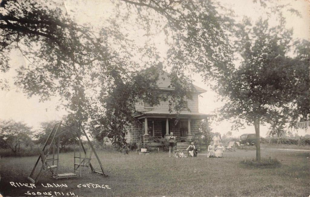 Historic Cottage With People And Swing