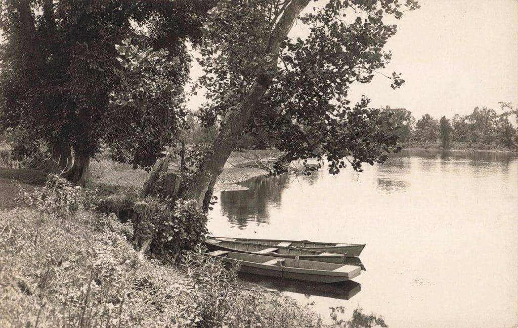 Boats By A Serene Riverbank