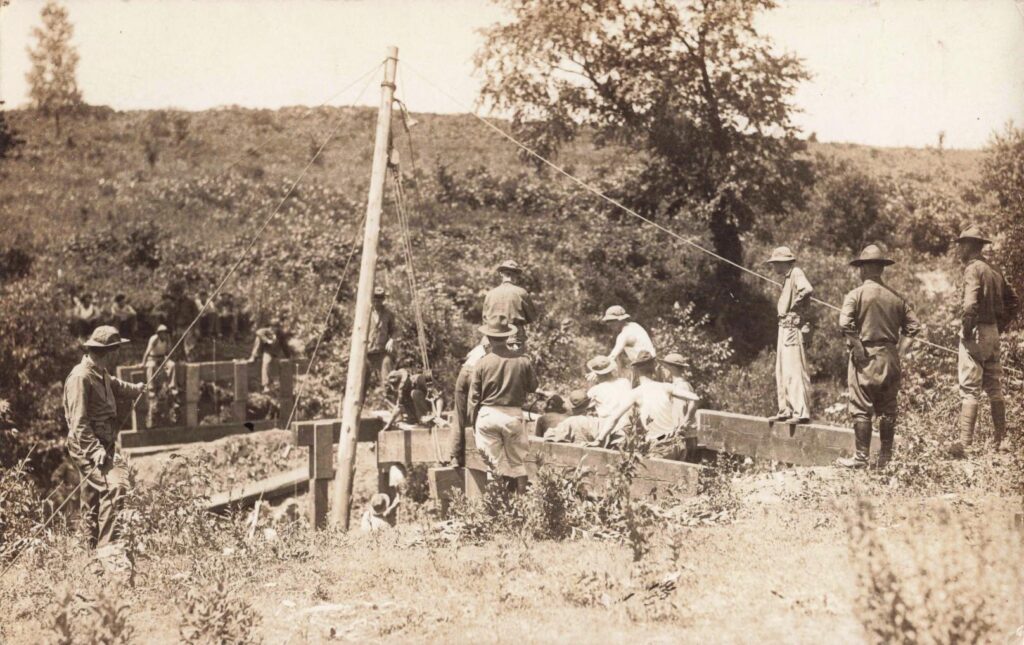 Men Working On A Wooden Structure.