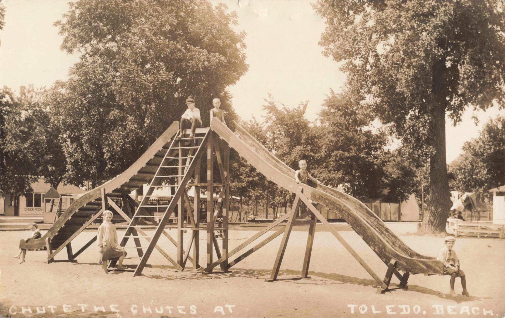 Wooden Water Chutes At Toledo Beach With Children Beside The Slide