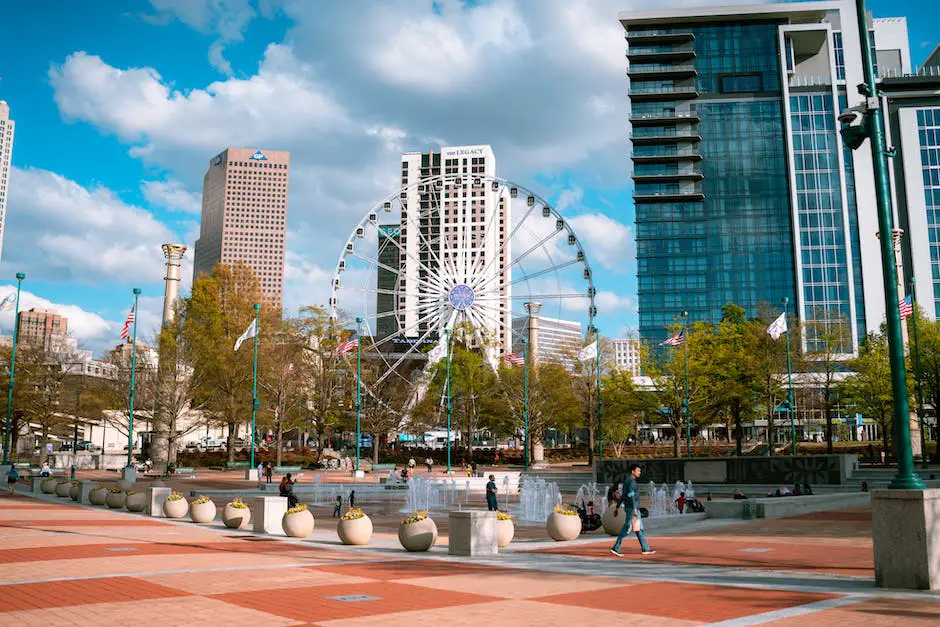 A Picturesque View Of Centennial Park With Lush Green Gardens, A Fountain, And People Enjoying The Serene Atmosphere.